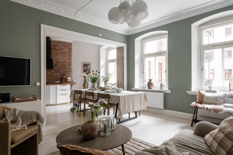 Open Plan Living Dining Room with Exposed Brick and Ornate Molding