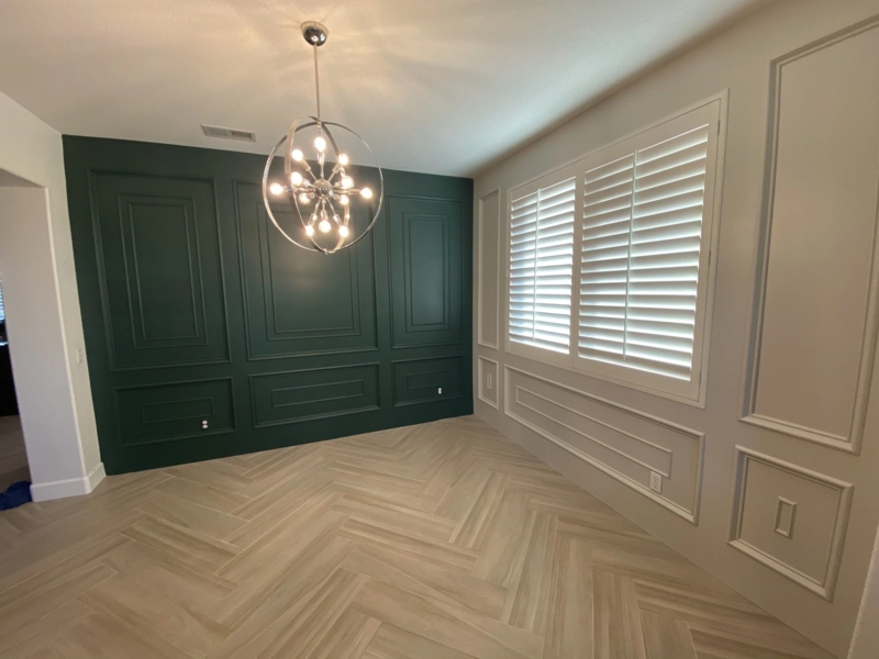 Orbital Chandelier in Dining Room with Dark Green Paneling