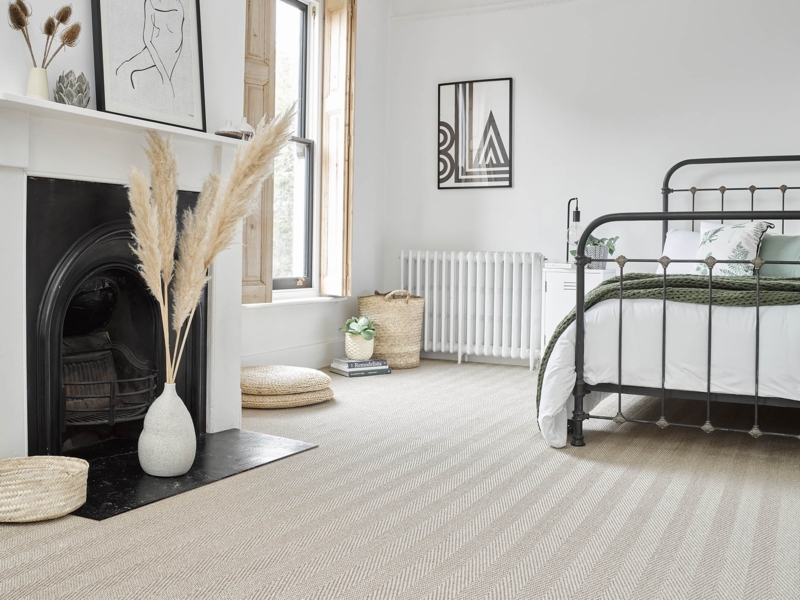 Organic Modern Bedroom with Chevron Sisal Flooring and Black Fireplace