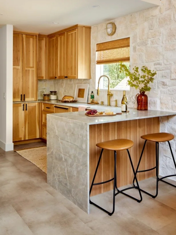 Organic Modern Kitchen with Stone Masonry Wall & Waterfall Edge