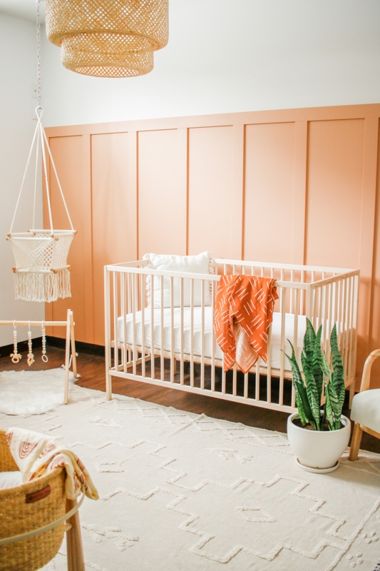 Peach Board and Batten Nursery with Light Wood Crib & Woven Pendant