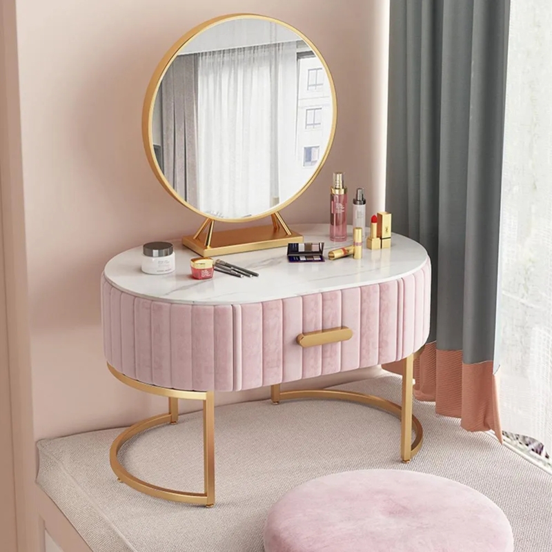 Pink Velvet Makeup Vanity with Oval Silhouette and Gold Pedestal Mirror