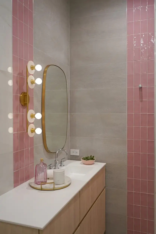 Pink Vertical Tile Bathroom Accent with Oval Gold Mirror