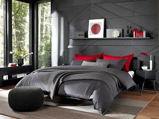 Platform Bed Geometric Accent Wall Red Pillows Knit Pouf