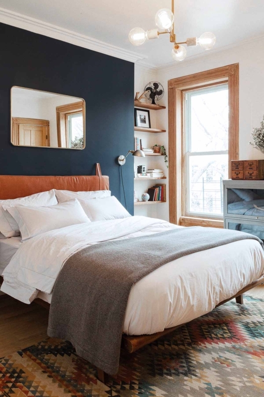 Platform Bed with Cognac Headboard against Navy Accent Wall