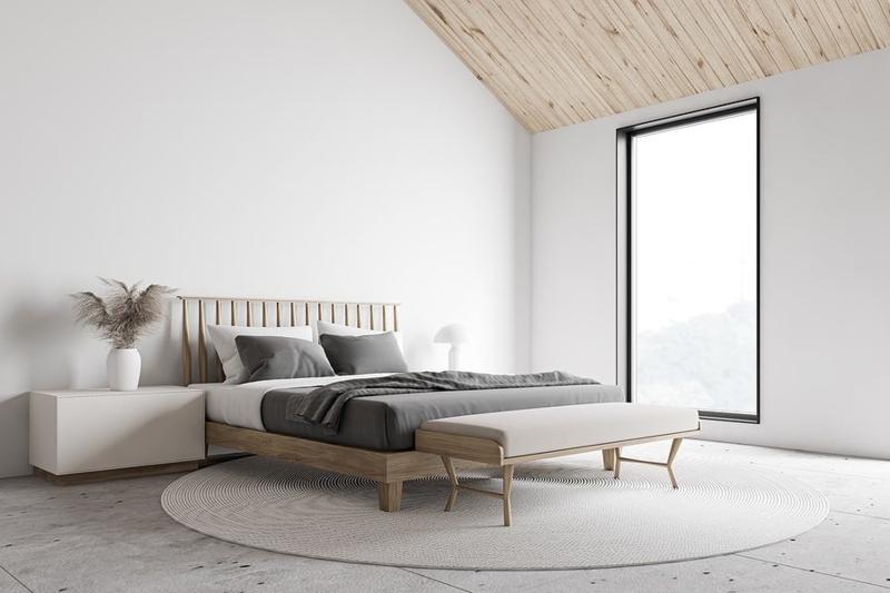 Platform Bed with Spindle Headboard under Vaulted Wood Ceiling.