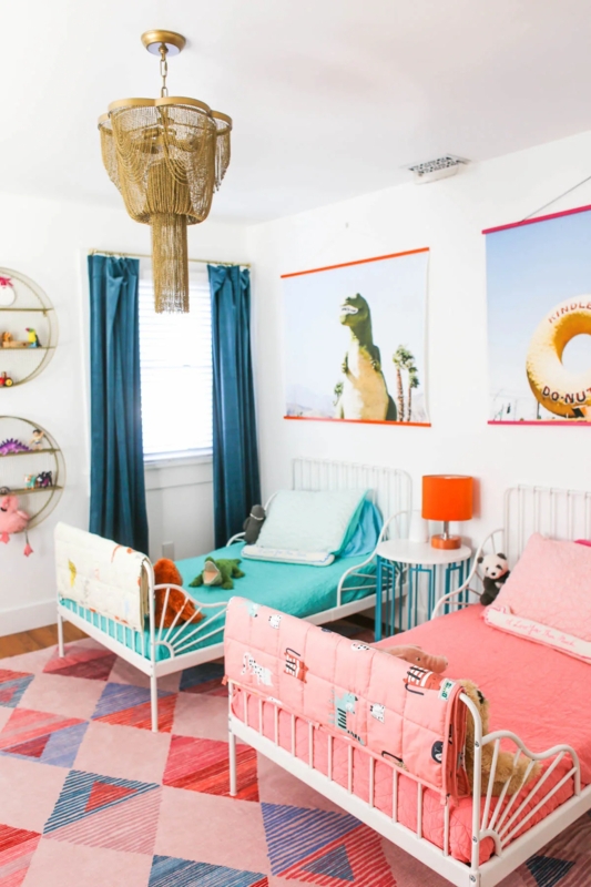 Playful Shared Bedroom with Spindle Beds and a Geometric Triangle Rug