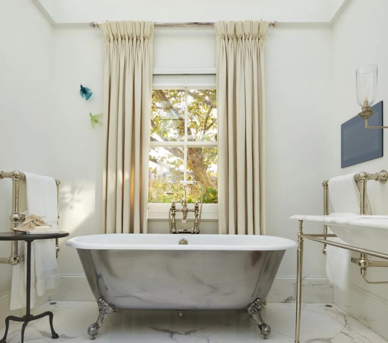 Polished Metal Slipper Tub with Claw Feet and Pinch Pleat Curtains
