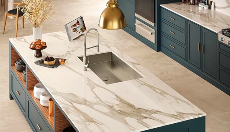 Polished Veined Stone Countertop paired with Teal Kitchen Cabinetry