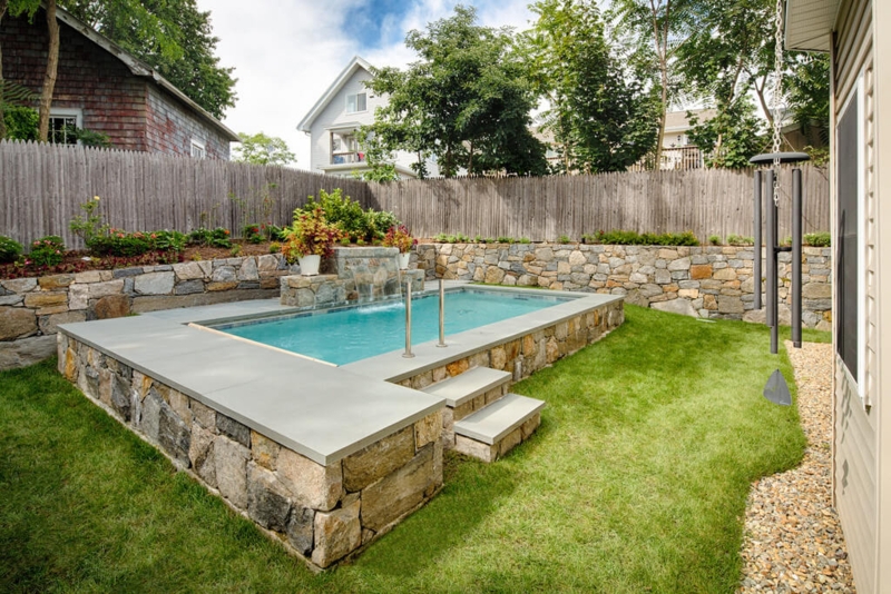 Raised Stone Swimming Pool with Integrated Waterfall