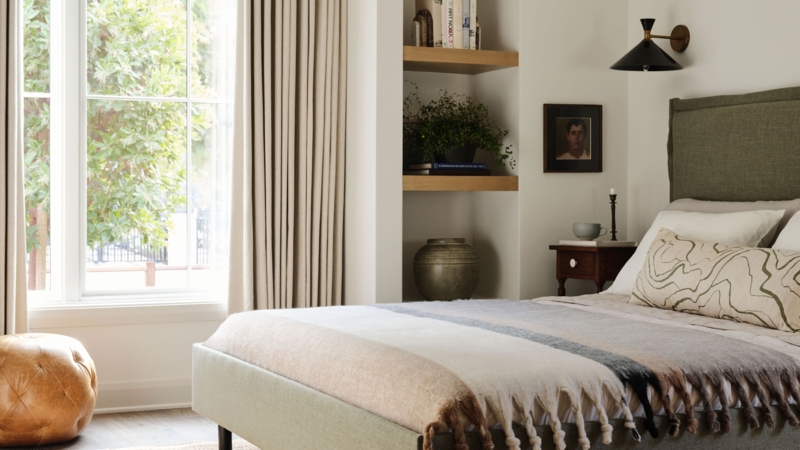 Recessed Built-in Shelving Nook next to Olive Green Upholstered Bed