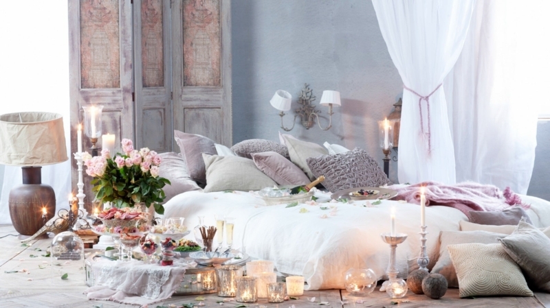Romantic Floor Bed Layout with Candlelight Ambiance and Layered Pillows