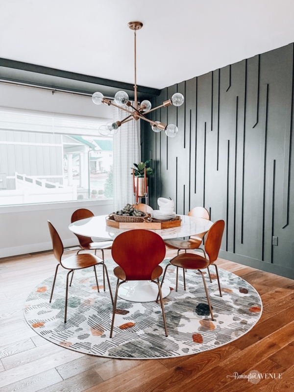Round White Pedestal Dining Table: Dark Green Geometric Accent Wall