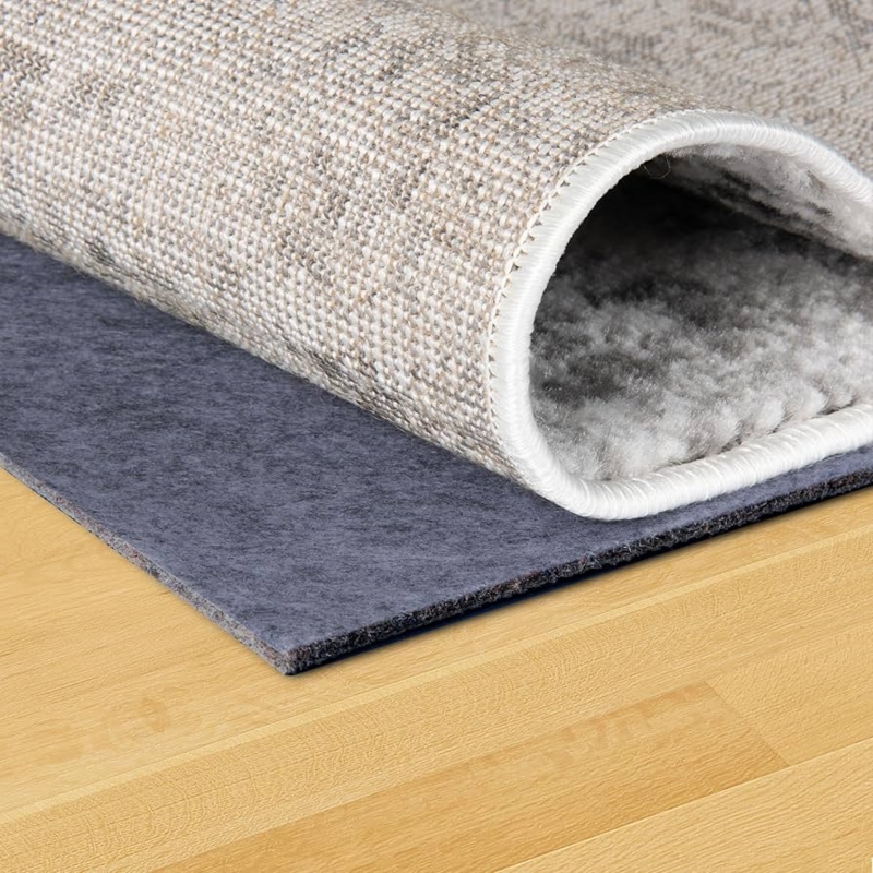 Rug Pad: Felt and Rubber Cushion under Distressed Blue Area Rug