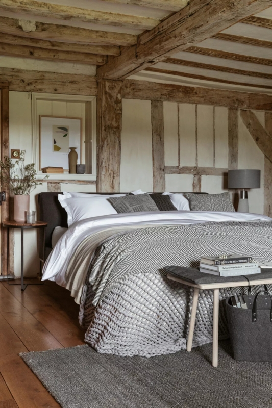 Rustic Bedroom Exposed Timber Framing With Chunky Knit Throw Decor