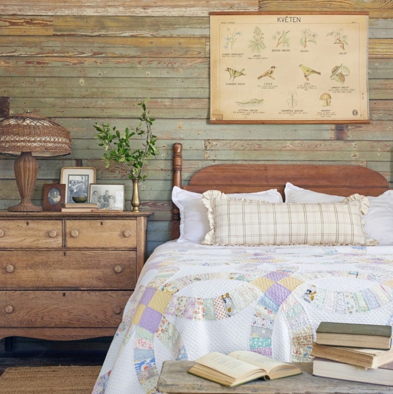 Rustic Bedroom With Wood Paneling And Cozy Double Wedding Ring Quilt