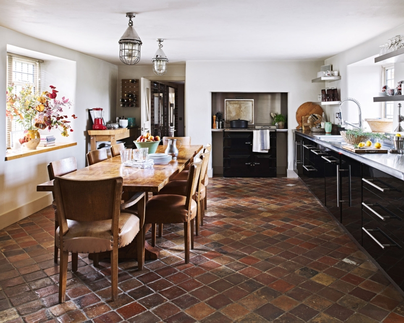 Rustic Kitchen with Diagonal Terracotta Tile Flooring and Black Cabinetry