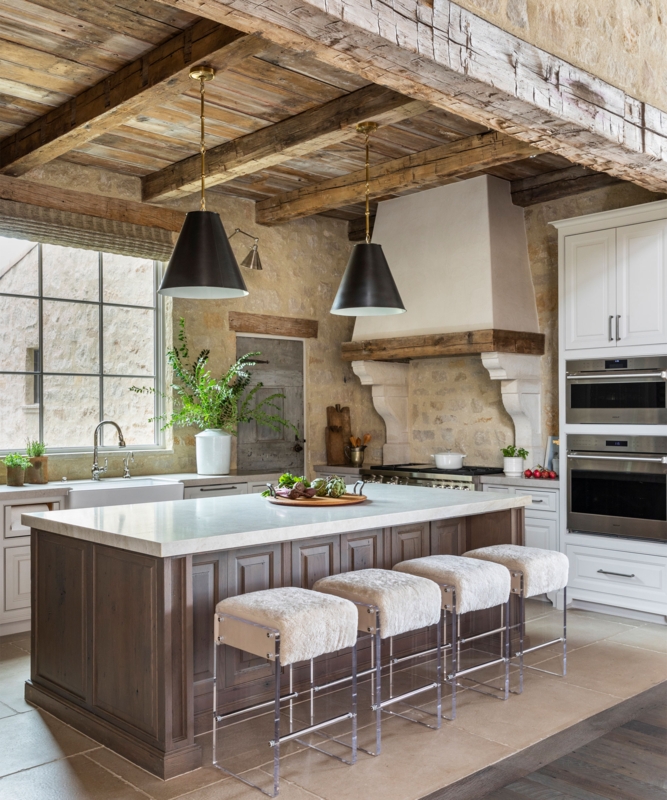 Rustic Kitchen with Exposed Beams, Stone Walls, and Acrylic Barstools