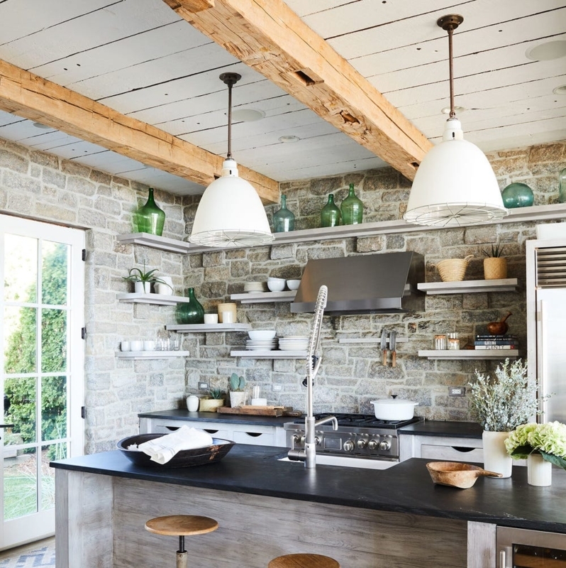Rustic Kitchen with Stone Walls and Black Island Countertop