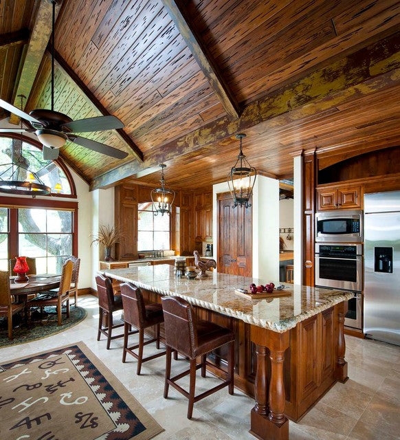 Rustic Kitchen with Vaulted Wood Ceiling, Beams, and Stone-Topped Island
