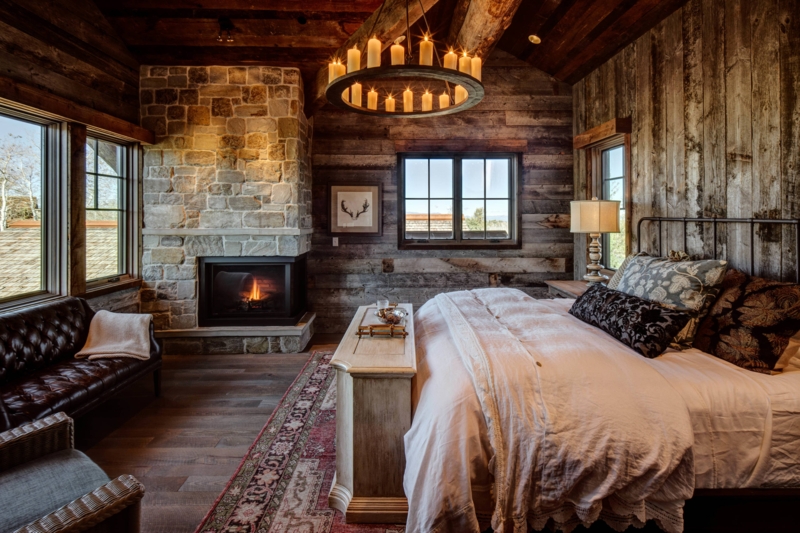 Rustic Lodge Bedroom: Stone Fireplace and Reclaimed Wood Walls