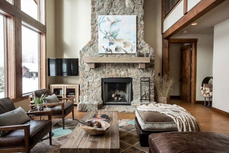 Rustic Lodge Living Room with Stone Fireplace and Reindeer Wall Art
