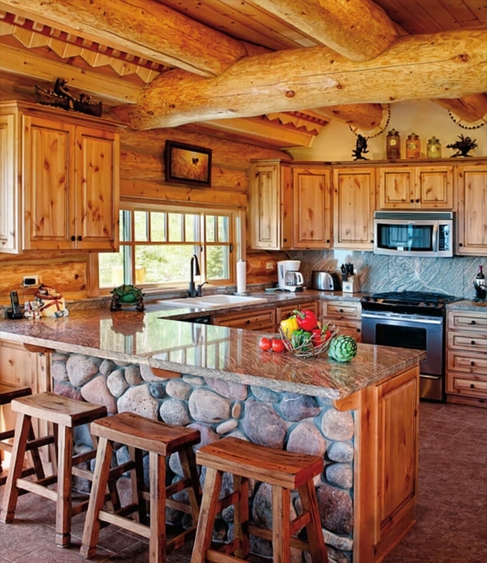 Rustic Log Cabin Kitchen with River Stone Island and Ceiling Beams