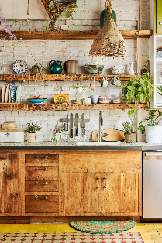 Rustic One-Wall Kitchen Layout with Floating Wood Shelves & Brick Wall