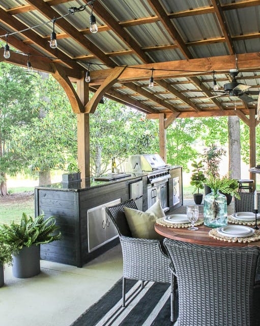 Rustic Timber Pavilion with Grill, Dark Cabinetry & Edison Lights