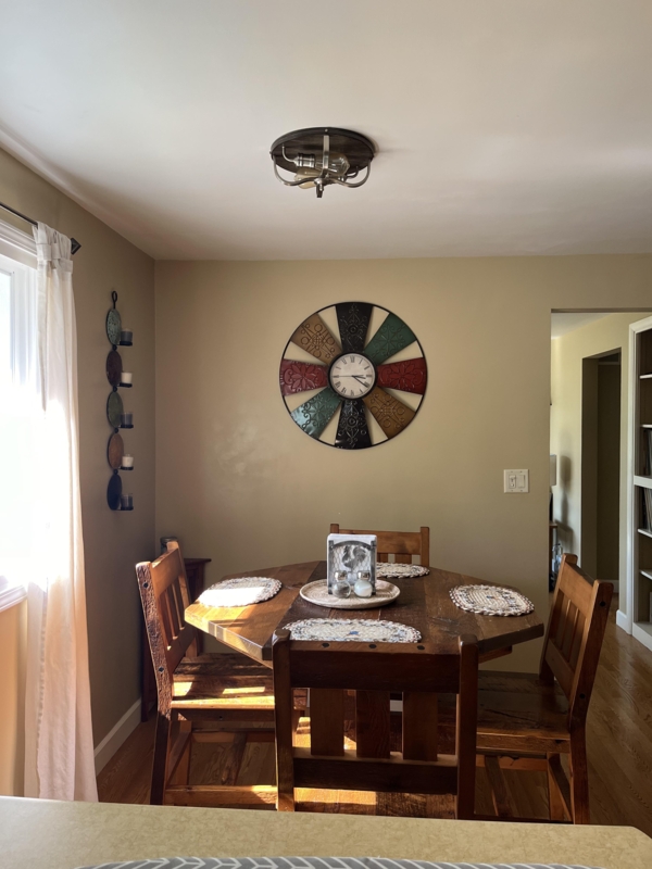 Rustic Wood Dining Nook: Clipped Corner Table & Colorful Oversized Clock