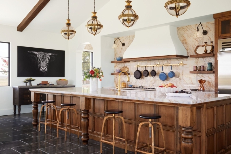 Rustic Wood Paneled Kitchen Island with Brass Orb Pendants