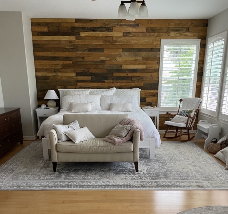 Rustic Wood Plank Accent Wall with Loveseat at Foot of Bed