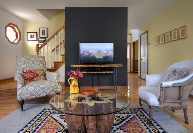 Rustic Wood Stump Coffee Table in Eclectic Navy Accent Wall Living Room