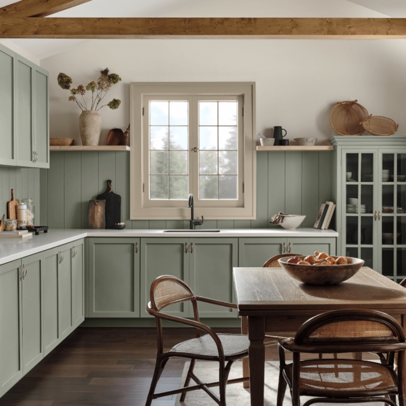 Sage Green Farmhouse Kitchen with Beadboard Walls and Cane Chairs.