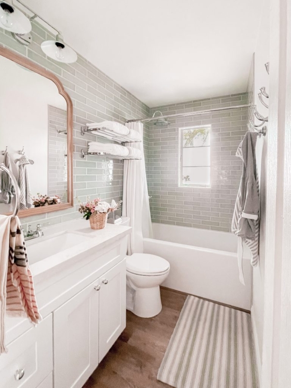Sage Green Subway Tile Bathroom with Arched Wood Mirror
