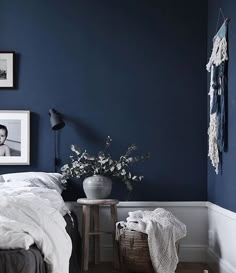 Scandinavian Bedroom Decor with Navy Walls and White Wainscoting