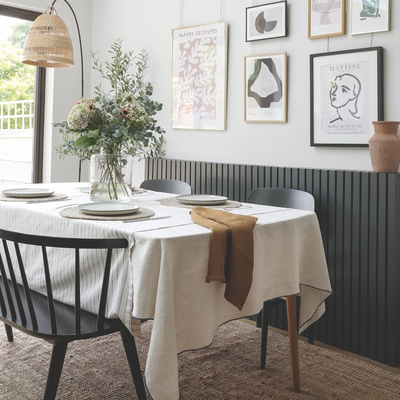 Scandinavian Dining: Dark Slatted Wall Paneling & Black Spindle Chairs