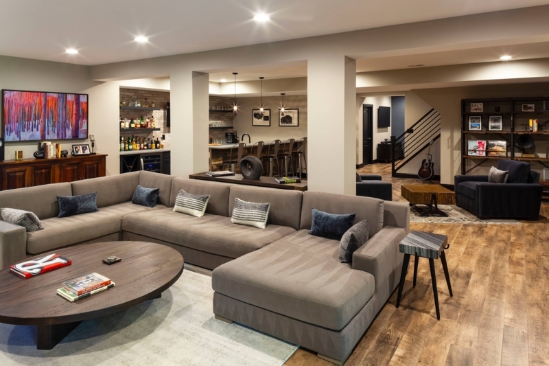 Sectional Sofa in Open Concept Basement Bar Layout with Wood Floors