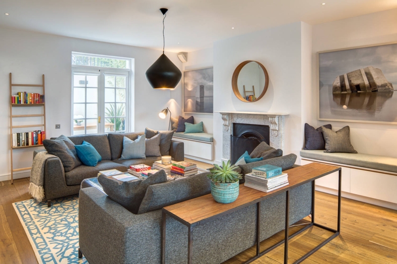 Sectional Sofa with Blue Geometric Rug, Built-in Benches & Fireplace