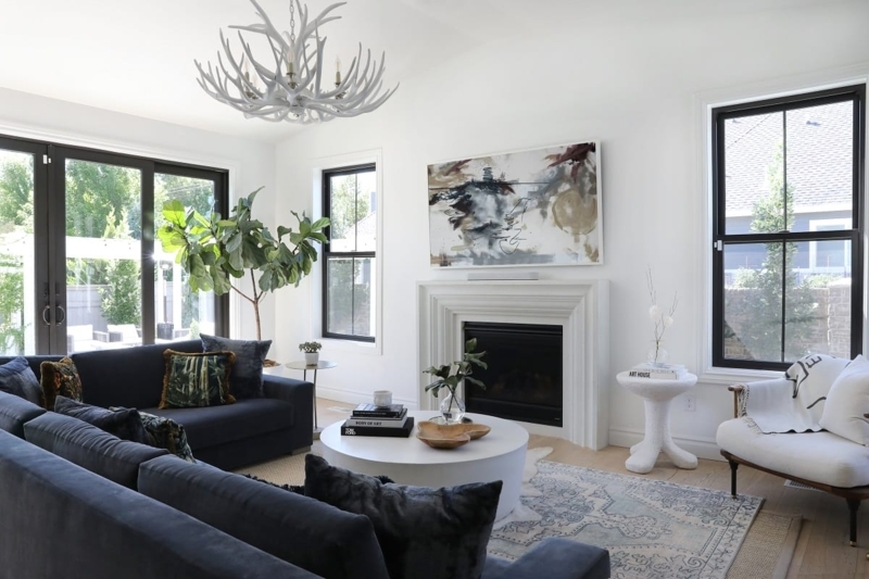Sectional Sofa with Stepped Fireplace Surround and Antler Chandelier