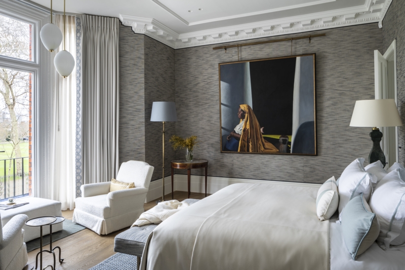Serene Bedroom with Textured Gray Wallpaper and Large Scale Portrait