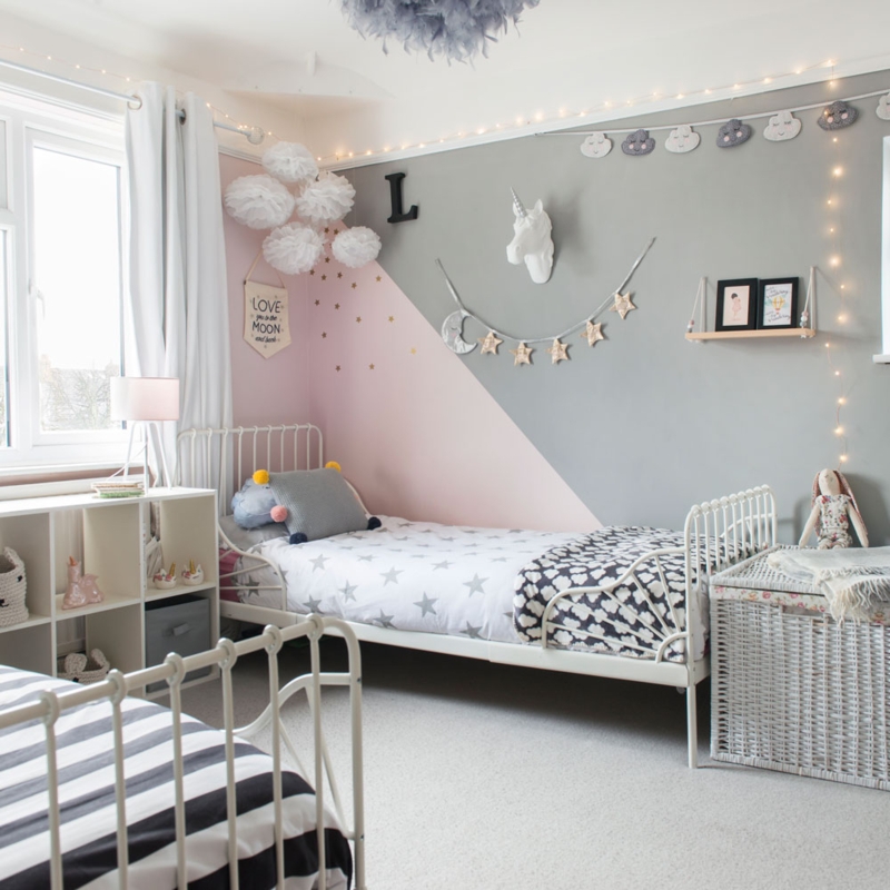 Shared Bedroom with Diagonal Wall Paint and White Metal Beds