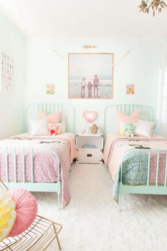Shared Bedroom with Symmetrical Mint Metal Beds and Floral Pastels