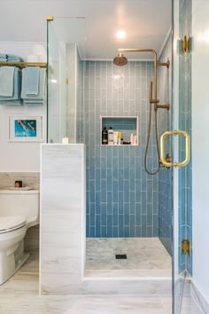 Shower Design: Vertical Blue Subway Tile with Aged Brass Fixtures