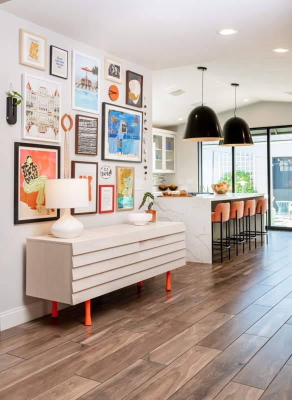 Slatted Wood Sideboard with Orange Legs and Eclectic Gallery Wall