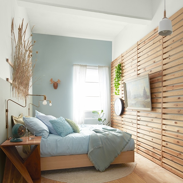 Slatted Wood Wall Paneling in Serene Light Blue Bedroom Retreat