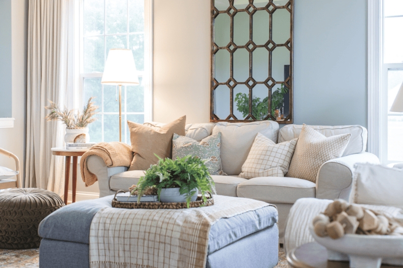 Slipcovered Sofa in Cozy Blue and Cream Living Room with Lattice Mirror