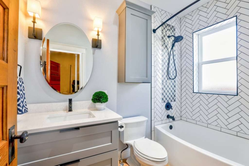 Small Bathroom Herringbone Tile Design, Grey Vanity, Black Hardware
