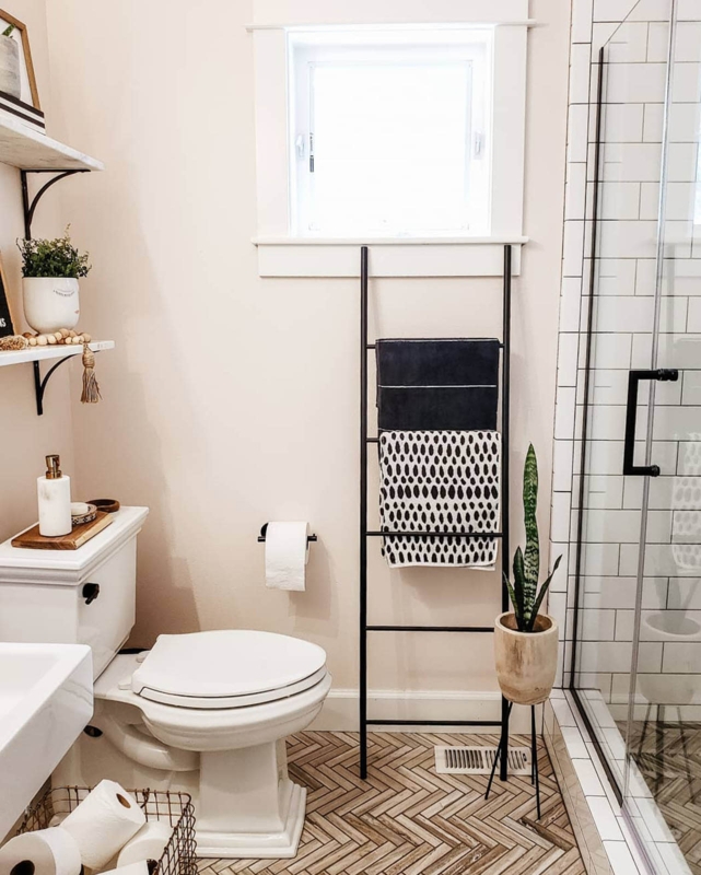 Small Bathroom Storage with Black Towel Ladder and Herringbone Floor