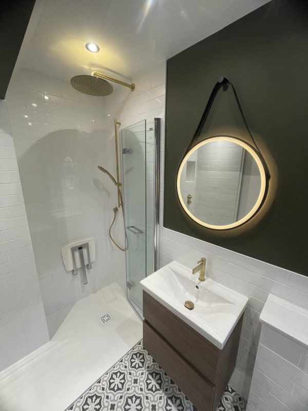 Small Bathroom with Green Accent Wall, Gold Fixtures & Backlit Mirror